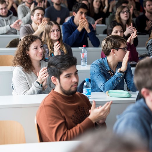 A class of students applauding 
