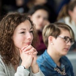 A women listening during a presentation